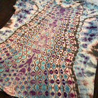 a tie dye t - shirt with a blue and purple design